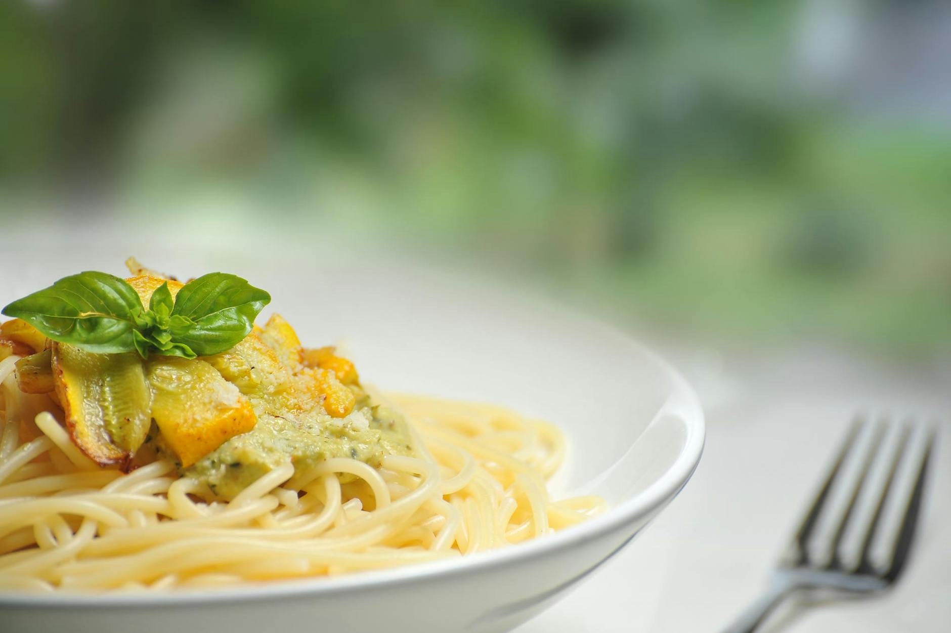 pasta on white bowl besides fork